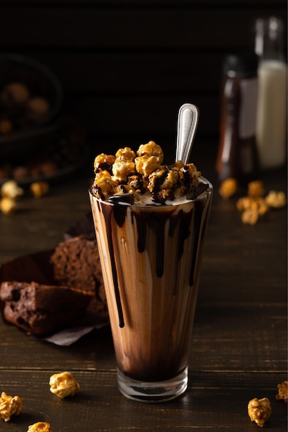 Photo cup with chocolate milkshake and caramel popcorn