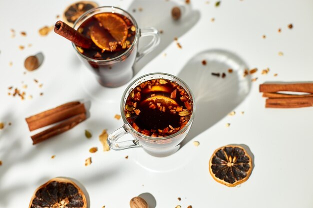 Cup with Christmas mulled red wine with spices and oranges