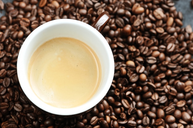 Cup with coffee and coffee beans