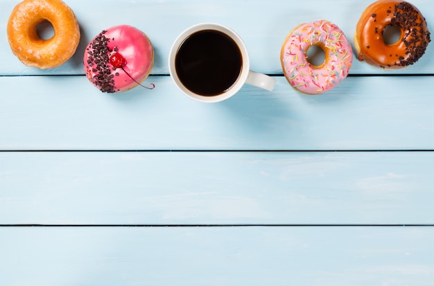 Cup with coffee and donuts