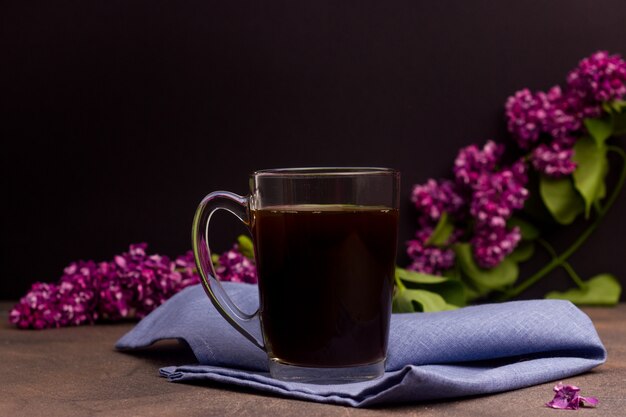 Cup with coffee on a table with flowers