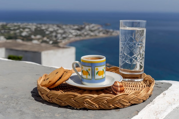 Cup with delicious hot coffee and biscuit closeup