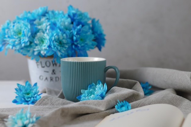 A cup with a drink and goodies is on the table