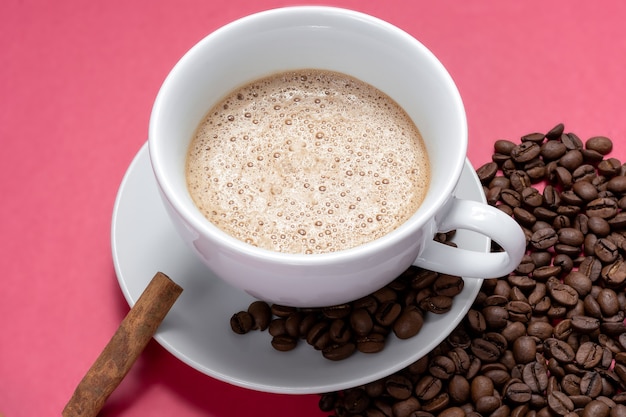 Cup with espresso latte and isolated on pink background