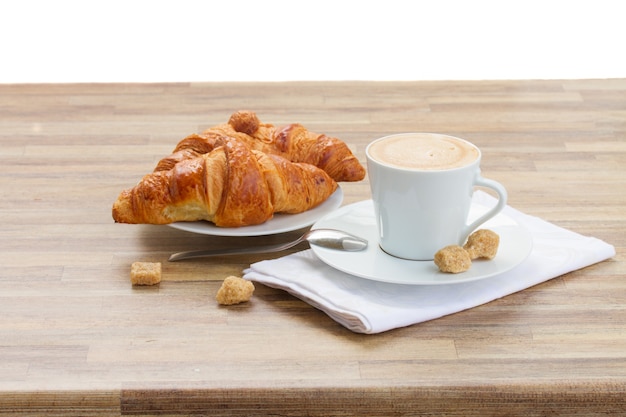 Cup with fresh espresso coffee and croissant isolated on white