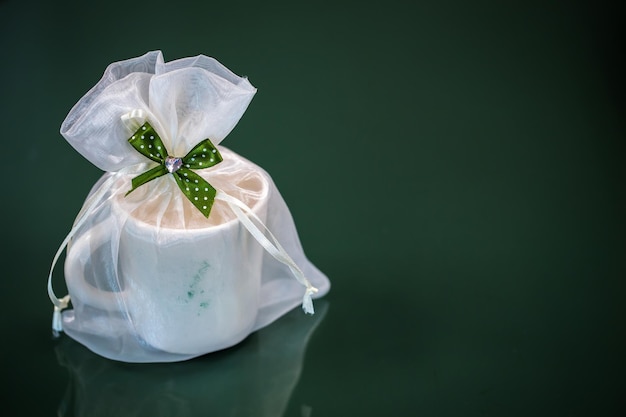 Cup with gifts on background