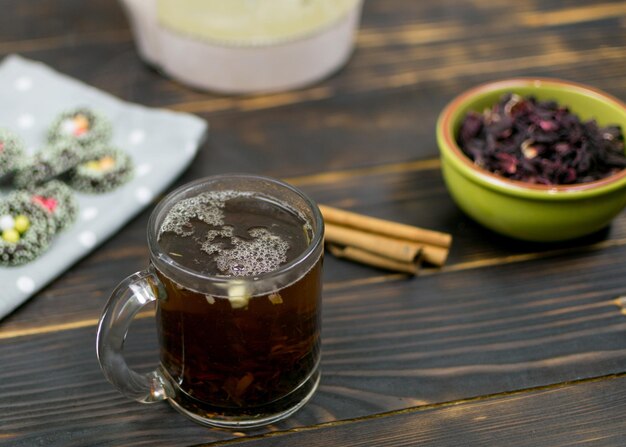 A cup with herbal tea on a dark background