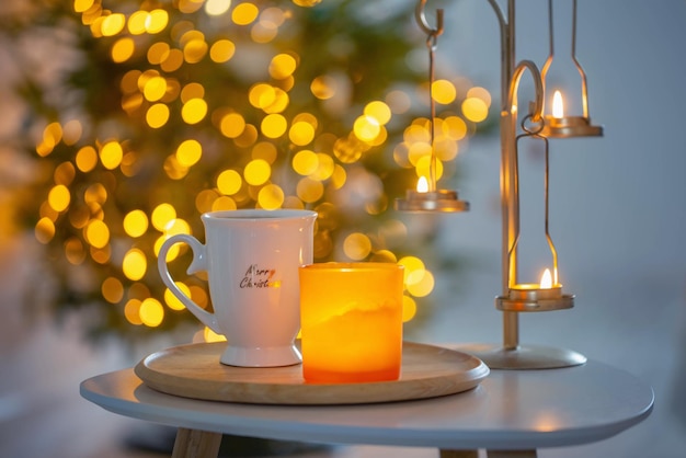 Cup with hot drink on background christmas tree