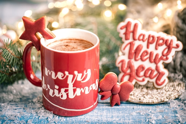 Cup with hot drink and gingerbread cookies close up.  the new year and winter home comfort.