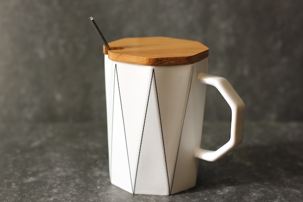 A cup with a lid and a spoon