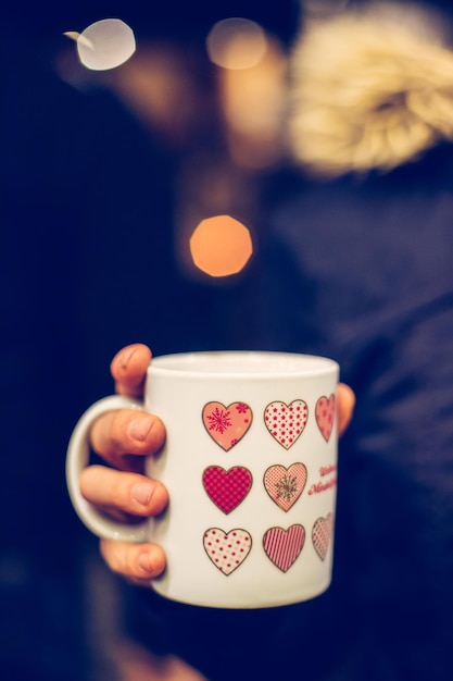 Cup with mulled wine on the christmas market copy space