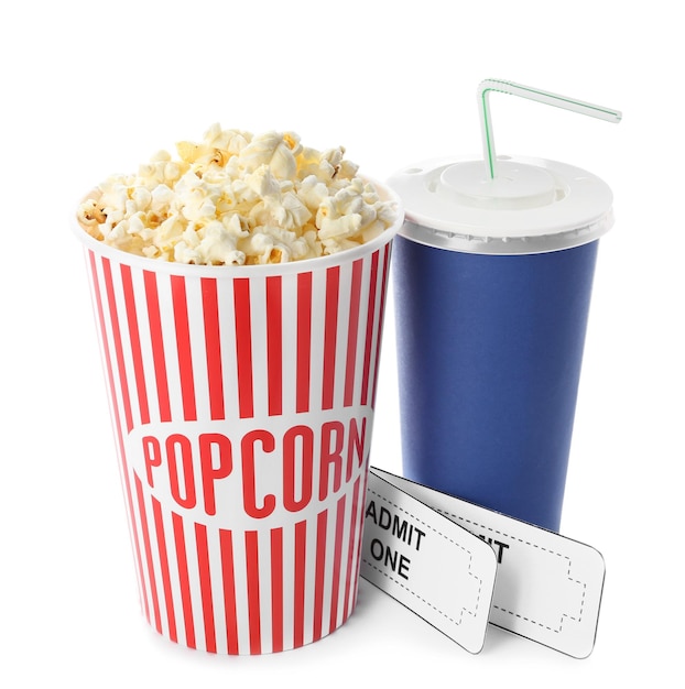 Cup with popcorn soda and cinema tickets on white background