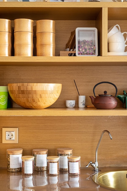 cupboard with accessories for Chinese tea ceremony in yoga studio tea jar kettle sink mugs