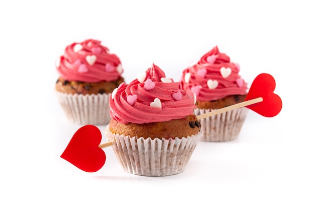 Cupcake decorated with sugar hearts and a cupid arrow for Valentine's Day isolated on white background