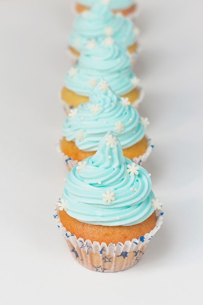 Cupcake decorated with sugar snowflakes and blue cream.Christmas winter cupcakes