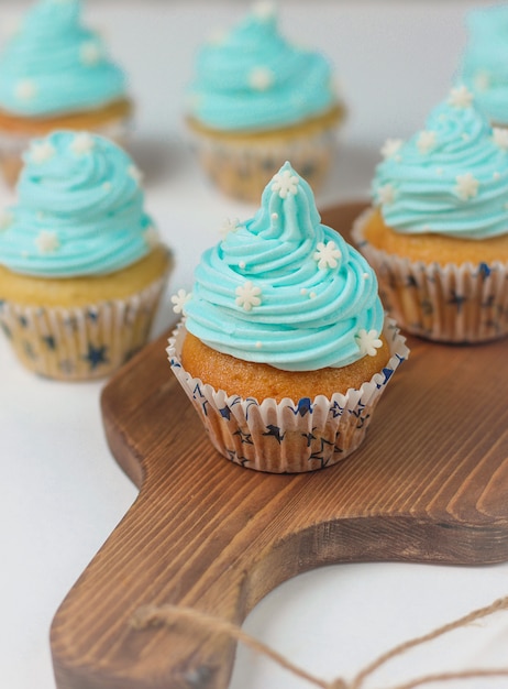 Cupcake decorated with sugar snowflakes and blue cream.Christmas winter cupcakes