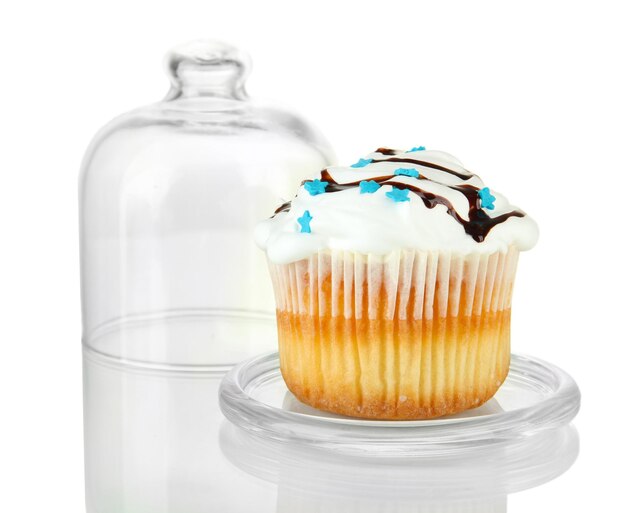 Cupcake on glass saucer isolated on white