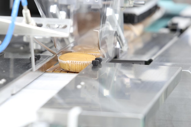 Cupcake packing machine food industrial business backgound selective focus