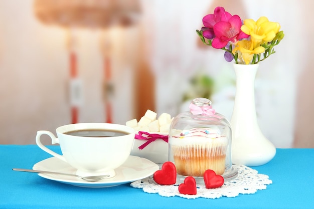 Cupcake on saucer with glass cover on bright background