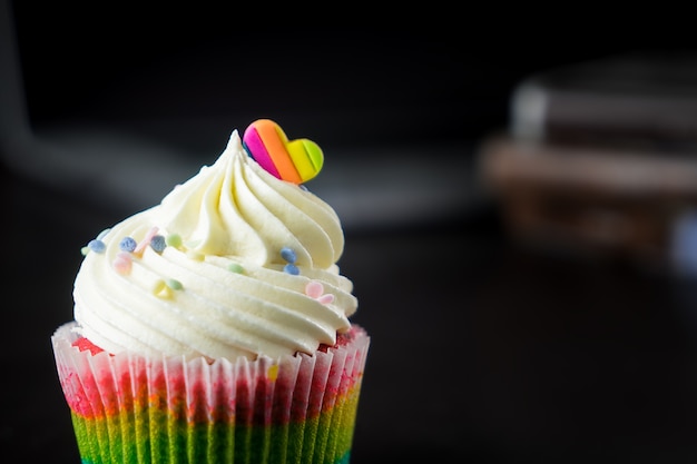 Cupcake topped with rainbow valentines heart