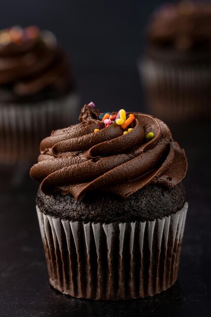 a cupcake with chocolate frosting and sprinkles on it