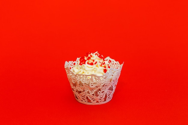 빨간색 배경에 섬세한 흰색 크림이 있는 컵케이크