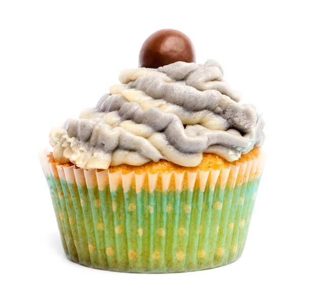 Cupcake with icing and chocolate decoration against white background in front of white background