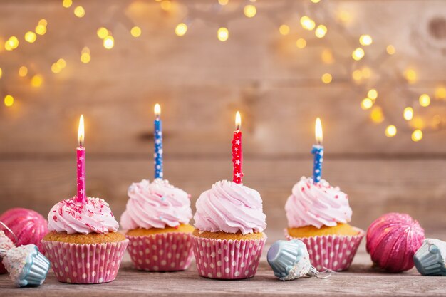 Cupcakes on dark old wooden background