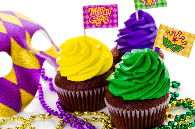 Cupcakes decorated with bright color icing for Mardi Gras party.