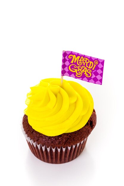 マルディグラのパーティーのために明るい色のアイシングで飾られたカップケーキ。