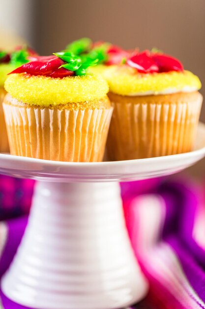 Cupcakes decorated with red chili peppers for Cinco de Mayo.