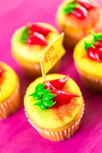 Cupcakes decorated with red chili peppers for Cinco de Mayo.