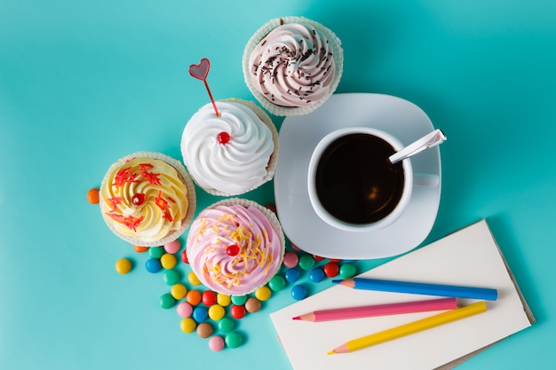 Cupcakes with colorful confetti and coffee cup