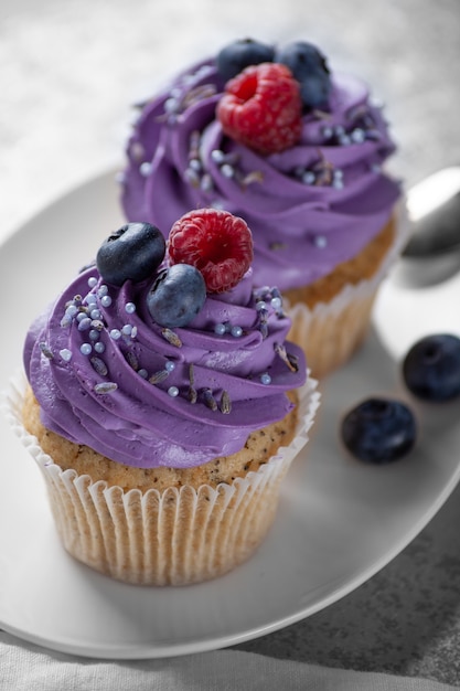 Cupcakes with cream on a white plate