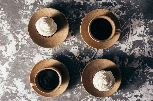 Cupcakes with cups of coffee.