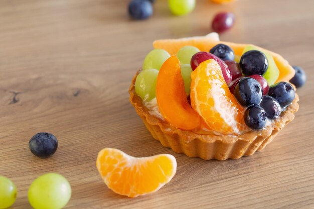 cupcakes with fruits on wooden table on kitchen