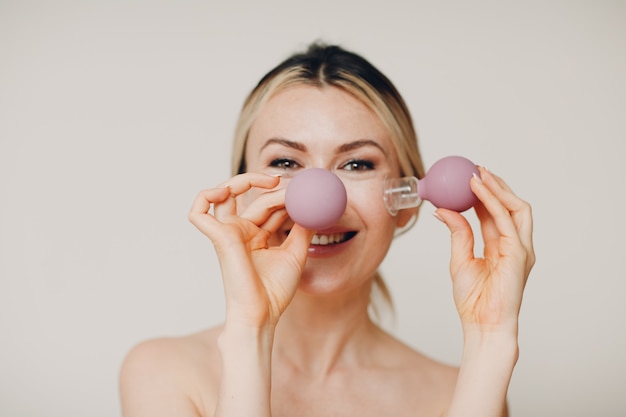 Cupping therapy and spa procedure, woman with little medical cup for face