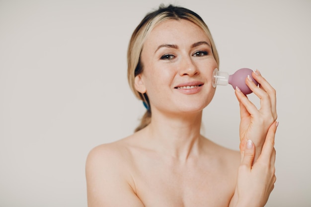 Photo cupping therapy and spa procedure woman with little medical cup for face