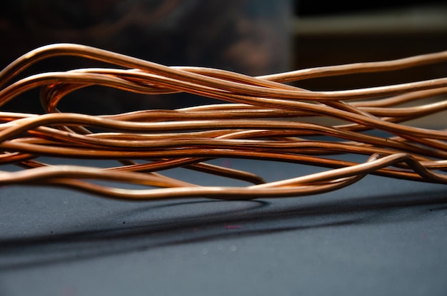 Cuprum copper in coils a lot of copper for the background color and texture of copper wire on a dark background