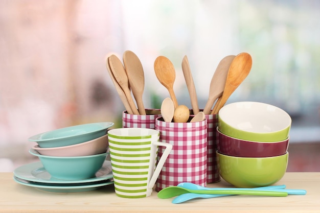 Cups bowls nd other utensils in metal containers isolated on light background