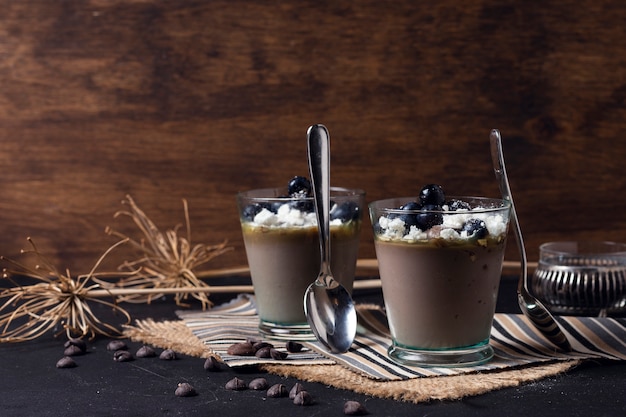 Cups of chocolate mousse with spoons