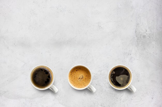 Cups of coffee on cement table