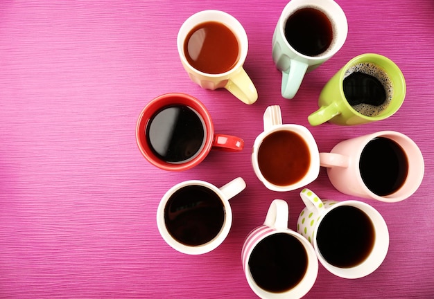 Cups of coffee on color background