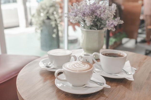 Cups of coffee on tray on table in cafe