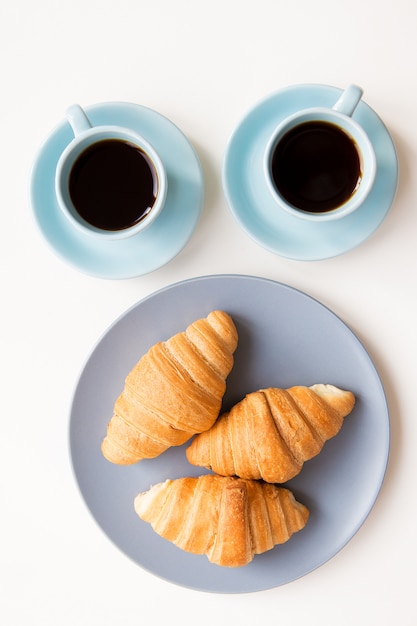 Cups of coffee with croissants