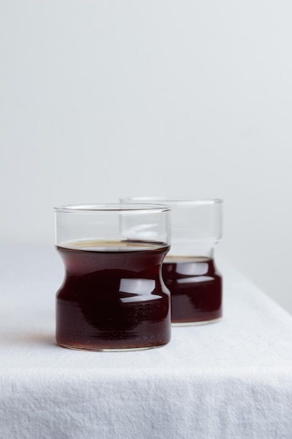 Cups of fresh coffee on white table