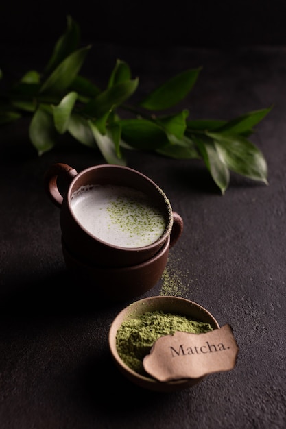 Photo cups of green matcha tea with milk