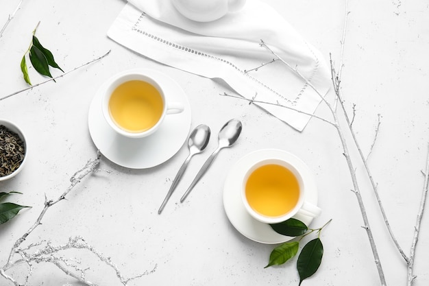 Cups of green tea on table