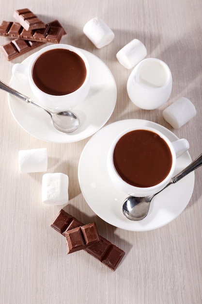 Cups of hot chocolate on table close up