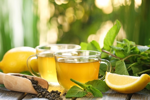 Cups of mint tea on table